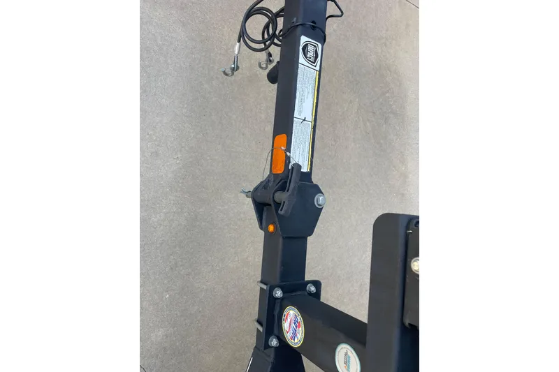 Slide: The Image of 2018 Tracker Pro Team 190 TX trailer hitch close-up with safety cables. - 5