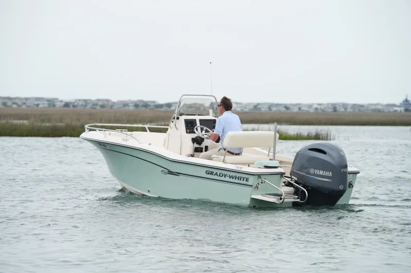 Slide: The Image of 2019 Grady-White Fisherman 180 boat on water, featuring Yamaha outboard motor. - 10
