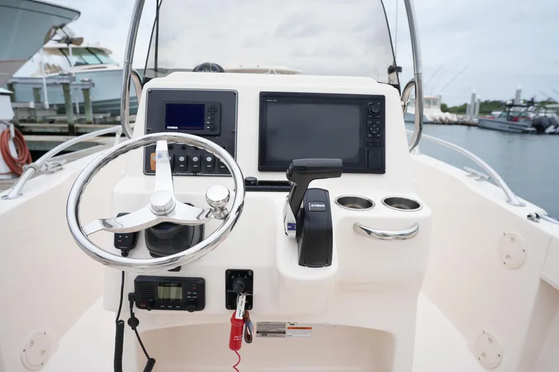 Slide: The Image of 2019 Grady-White Fisherman 180 boat console with steering wheel and navigation controls. - 16