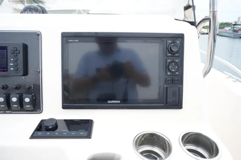 Slide: The Image of Control panel of 2019 Grady-White Fisherman 180 with Garmin display and cup holders. - 19