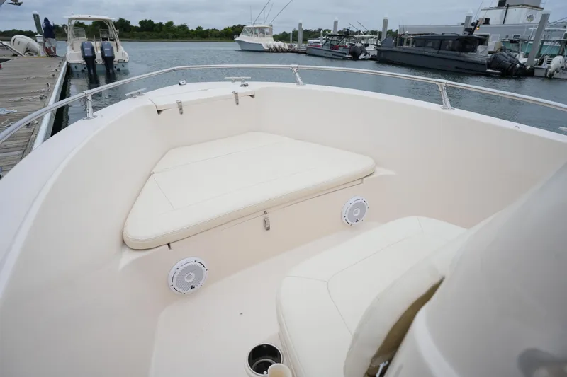 Slide: The Image of 2019 Grady-White Fisherman 180 boat interior with cushioned seating at marina. - 21