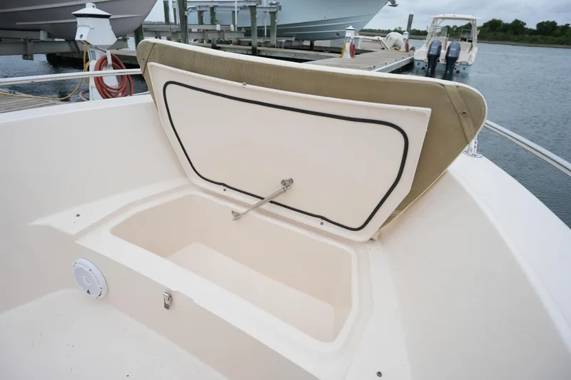 Slide: The Image of 2019 Grady-White Fisherman 180 boat storage compartment open at dock. - 24