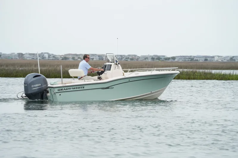 Slide: The Image of 2019 Grady-White Fisherman 180 boat cruising on calm waters with Yamaha engine. - 5