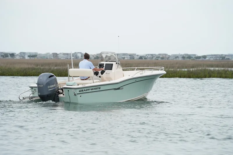 Slide: The Image of 2019 Grady-White Fisherman 180 boat cruising on calm water with scenic background. - 6