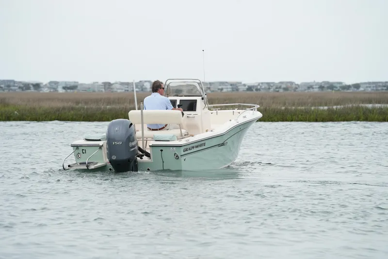 Slide: The Image of 2019 Grady-White Fisherman 180 boat cruising on calm water near marshland. - 7
