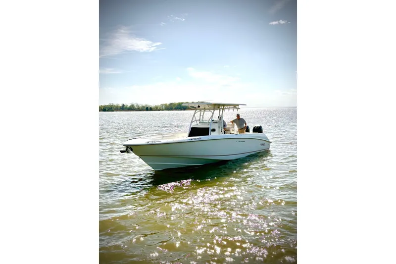 The Image of 2005 Boston Whaler 320 Outrage boat docked on a sunny day. - 0