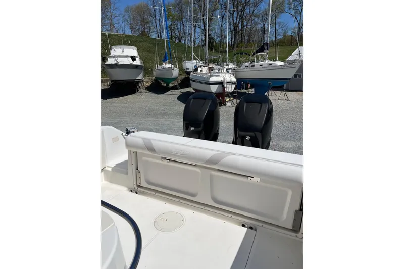 Slide: The Image of 2005 Boston Whaler 320 Outrage boat storage compartment open on deck. - 13
