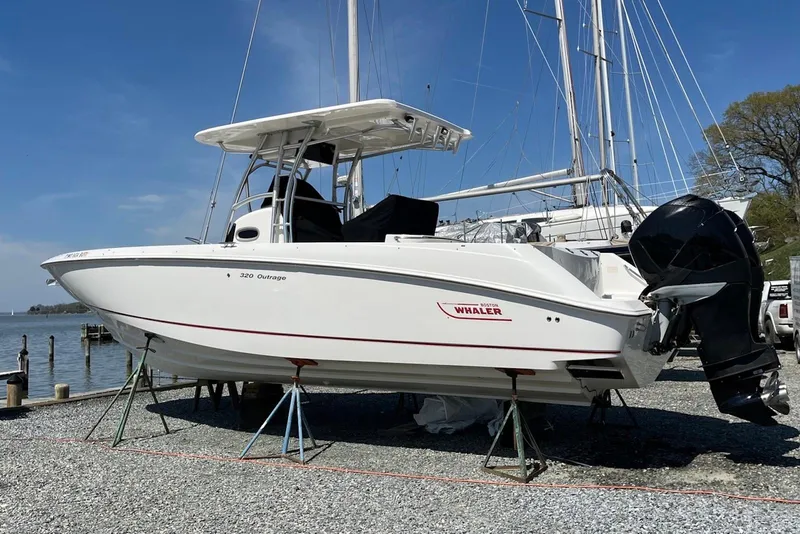 Slide: The Image of 2005 Boston Whaler 320 Outrage boat seats, featuring plush white upholstery. - 18