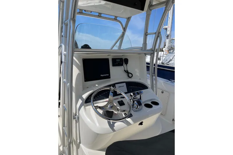 Slide: The Image of 2005 Boston Whaler 320 Outrage boat on calm water under clear sky. - 2