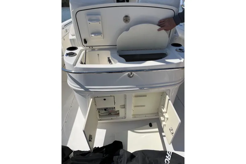 Slide: The Image of 2005 Boston Whaler 320 Outrage boat interior with open storage compartments. - 23