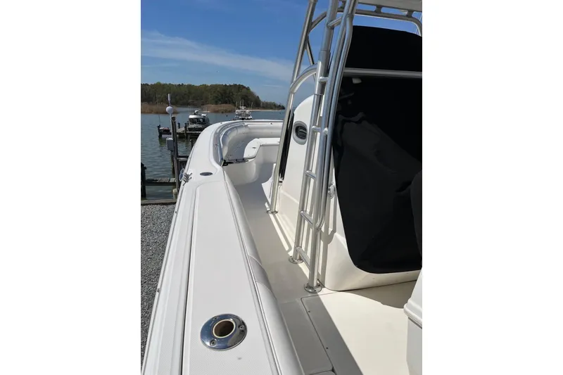 Slide: The Image of 2005 Boston Whaler 320 Outrage boat docked, showcasing sleek design and sturdy construction. - 26