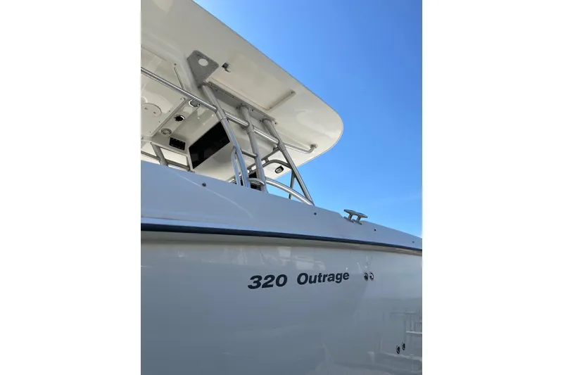 Slide: The Image of 2005 Boston Whaler 320 Outrage boat against clear blue sky. - 27
