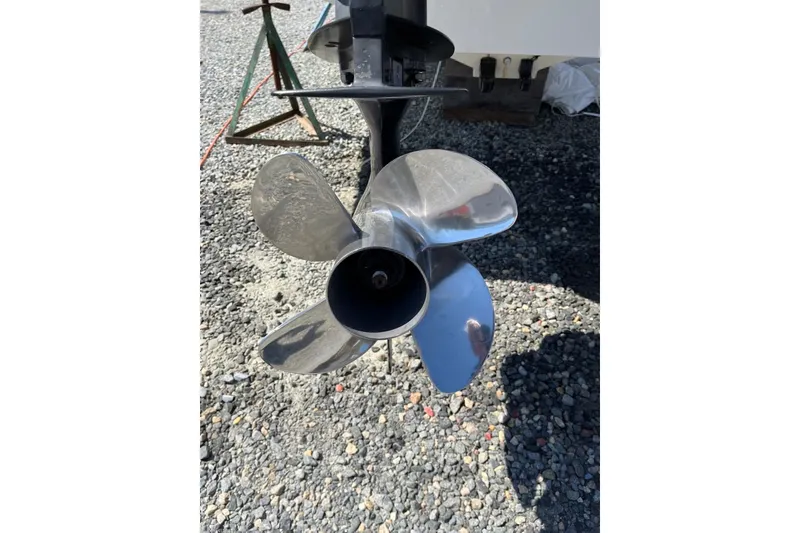 Slide: The Image of Propeller of a 2005 Boston Whaler 320 Outrage on gravel surface. - 29