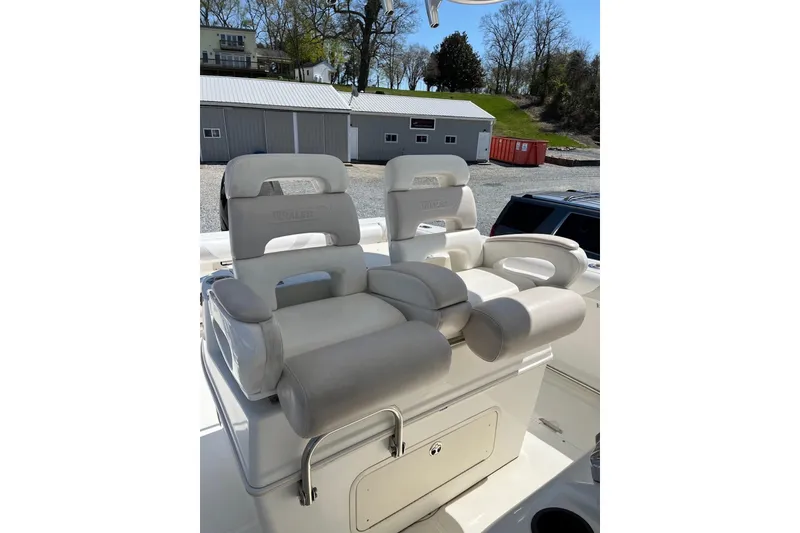 Slide: The Image of 2005 Boston Whaler 320 Outrage boat docked on a lift by the water. - 4