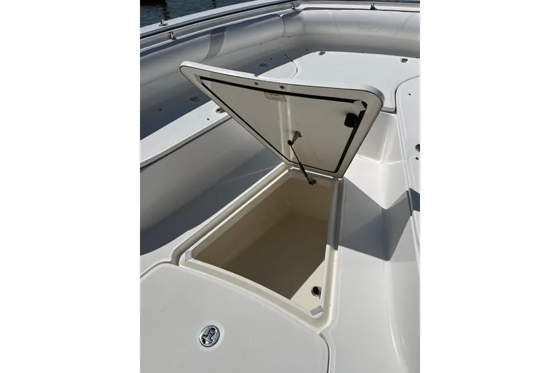 Slide: The Image of 2005 Boston Whaler 320 Outrage boat docked by the water on a sunny day. - 5
