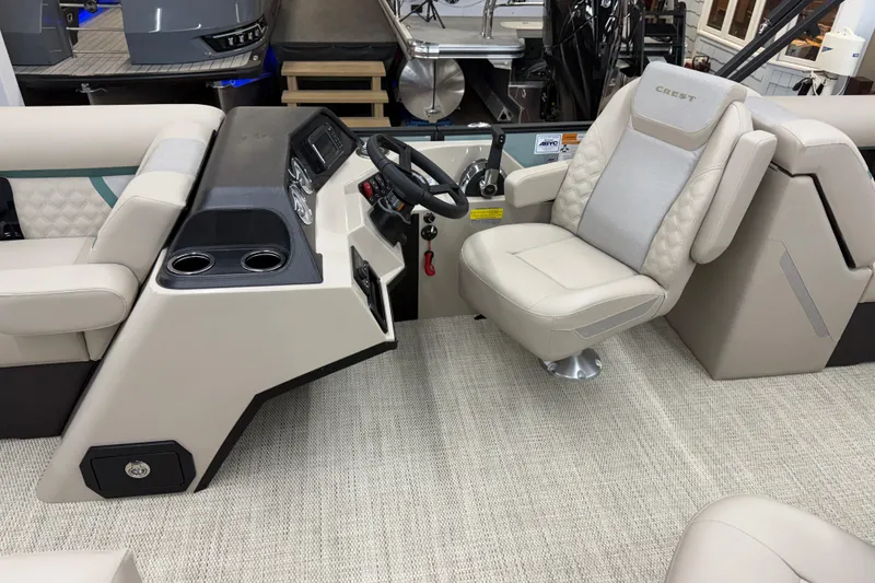 Slide: The Image of 2026 Crest Conquest 230 SLC boat interior with captain's chair and control console. - 5