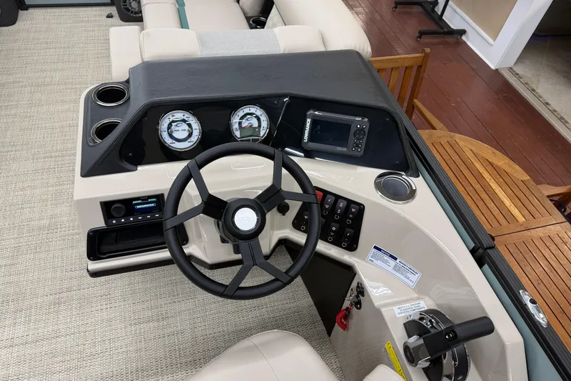 Slide: The Image of 2026 Crest Conquest 230 SLC boat dashboard with steering wheel, gauges, and controls. - 8