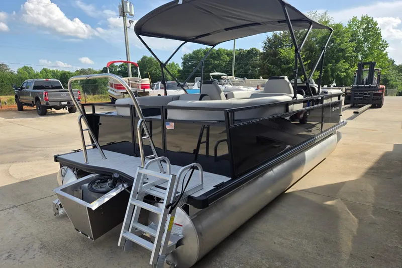 Slide: The Image of 2026 Dockside 22DQ2.75 pontoon boat with canopy, parked outdoors on a sunny day. - 16