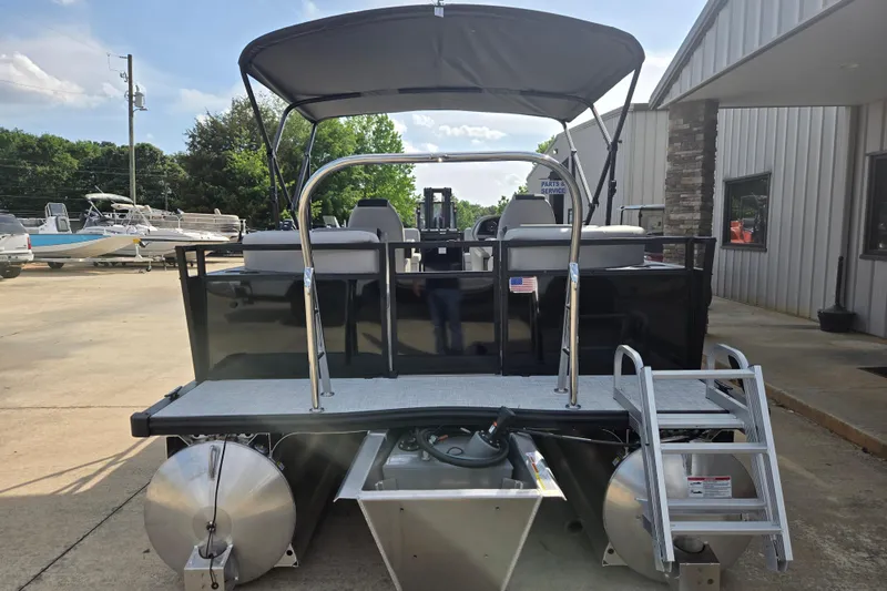 Slide: The Image of Pontoon boat Dockside 22DQ2.75, 2026 model, with canopy and ladder, docked outdoors. - 17