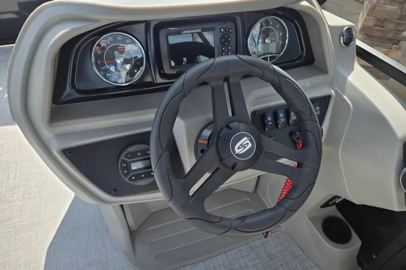 Slide: The Image of Steering wheel and dashboard of 2026 Dockside 22DQ2.75 boat with gauges and controls. - 7
