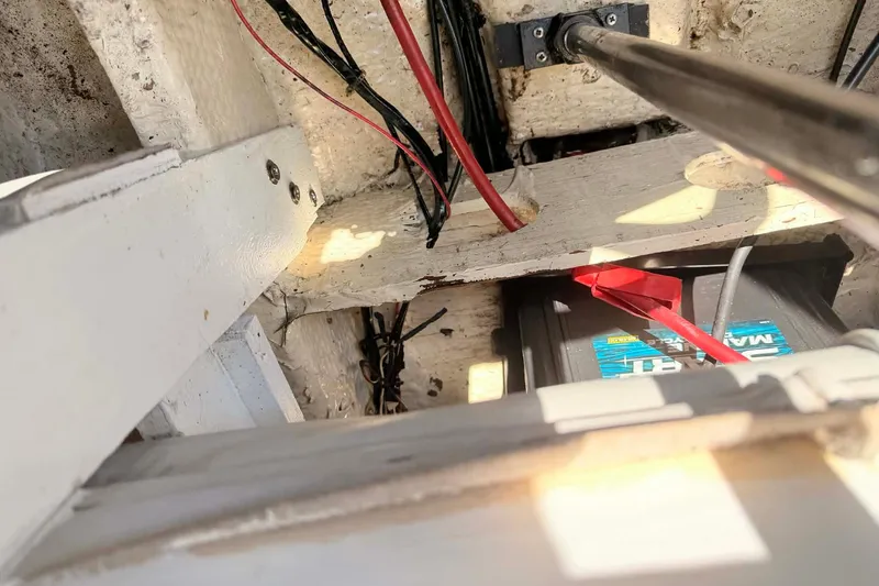 Slide: The Image of 1984 Century Resorter boat interior showing wiring and battery setup. - 2