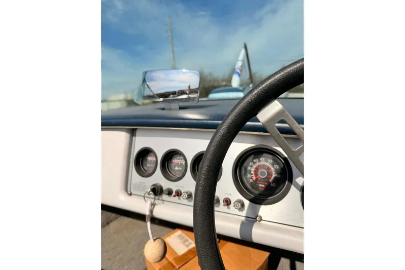 Slide: The Image of 1984 Century Resorter dashboard with gauges and steering wheel under a clear sky. - 4