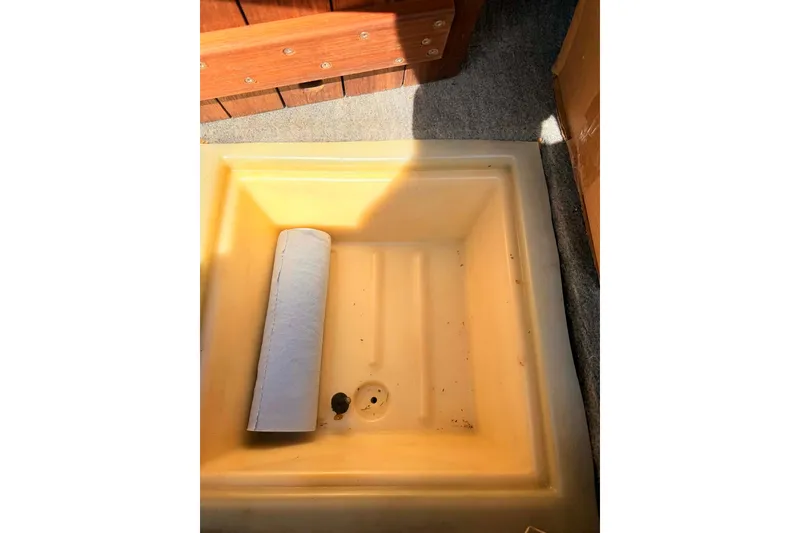 Slide: The Image of 1984 Century Resorter boat interior with a yellow compartment and rolled-up item. - 5