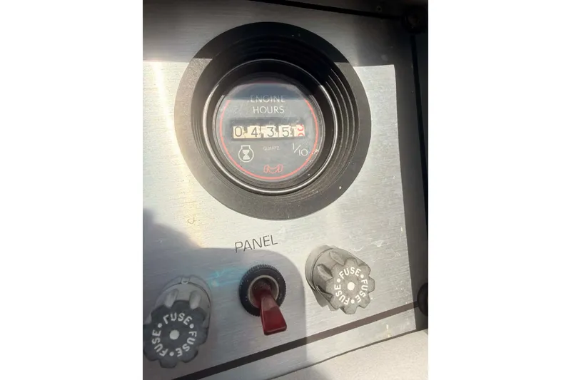 Slide: The Image of Control panel of a 1984 Century Resorter showing engine hours and fuse switches. - 8