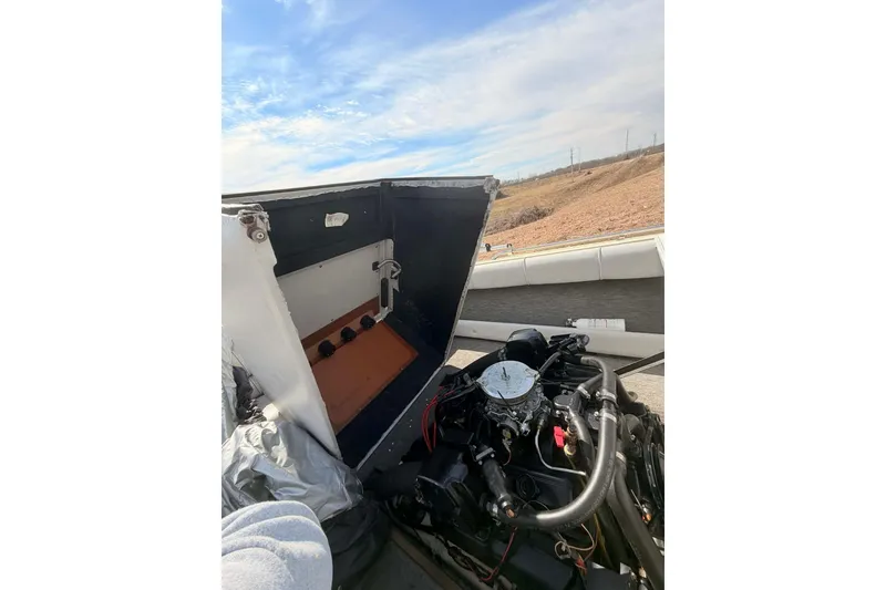 Slide: The Image of Open engine compartment of a 1984 Century Resorter boat under a clear sky. - 9