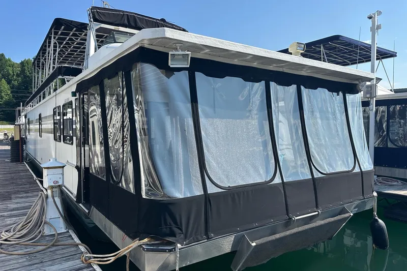 Slide: The Image of Houseboat docked at marina, Lakeview 15x70 model, 1995, with covered deck area. - 10