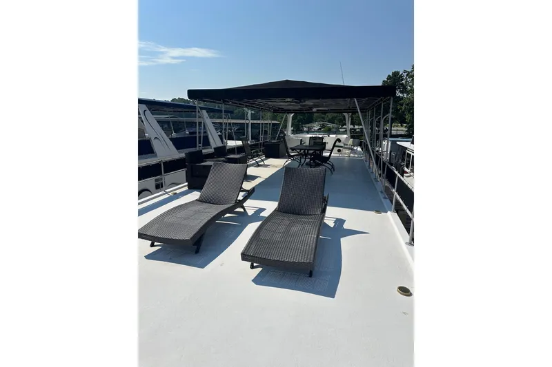 Slide: The Image of Rooftop deck of 1995 Lakeview 15x70 houseboat with lounge chairs and canopy. - 11