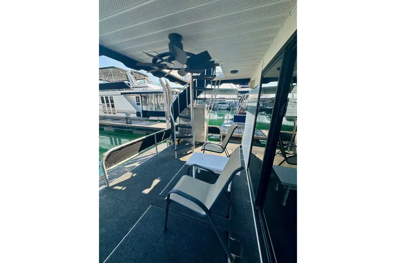 Slide: The Image of Outdoor deck of 1995 Lakeview 15x70 houseboat with chairs and ceiling fan. - 12