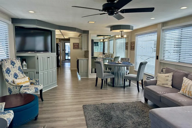 Slide: The Image of Modern Lakeview 15x70 houseboat interior, featuring cozy living area, dining space, and stylish decor. - 14