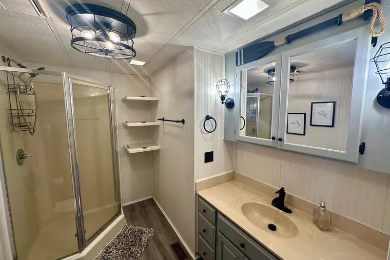 Slide: The Image of Modern bathroom in a 1995 Lakeview 15x70, featuring shower and vanity. - 8
