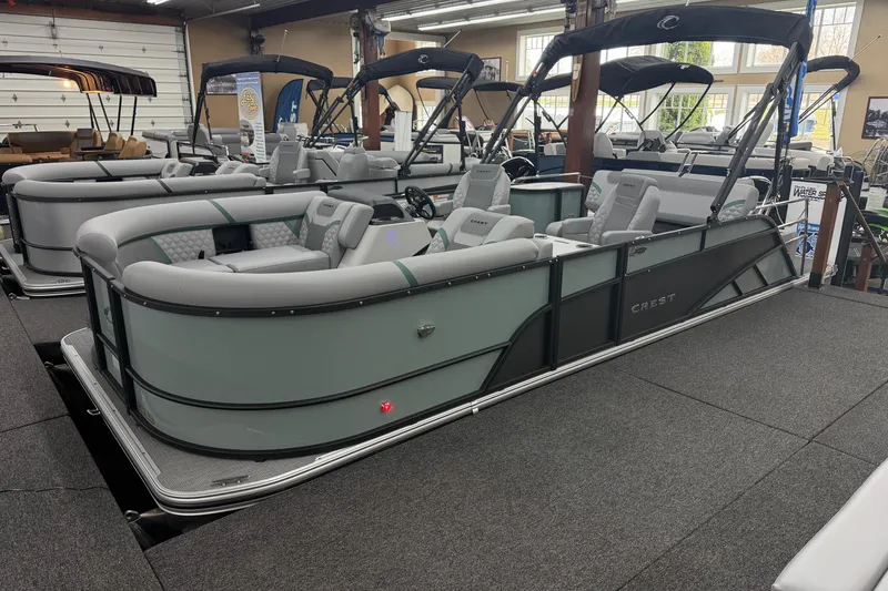 The Image of 2026 Crest Conquest 230 SLSC pontoon boat displayed in a showroom. - 1