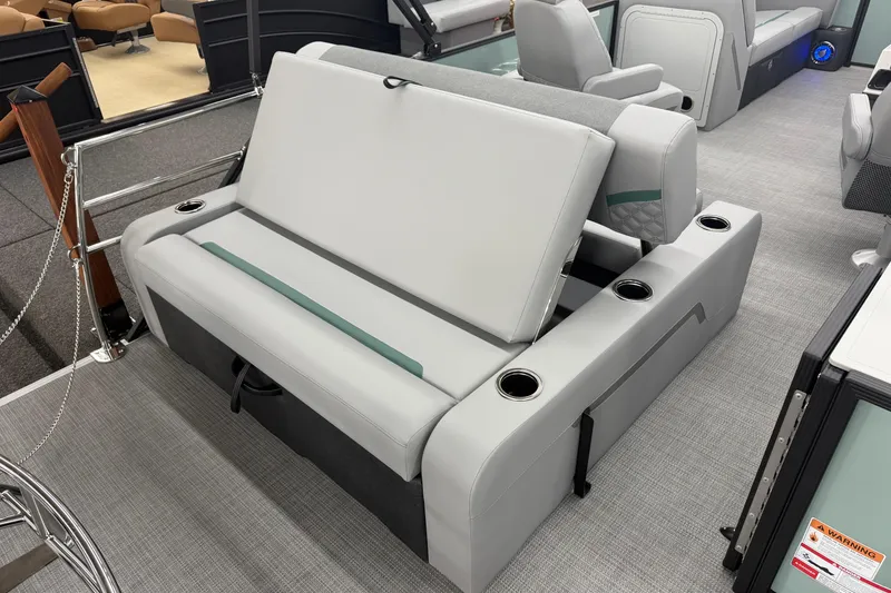 Slide: The Image of 2026 Crest Conquest 230 SLSC boat interior with gray seating and cup holders. - 12