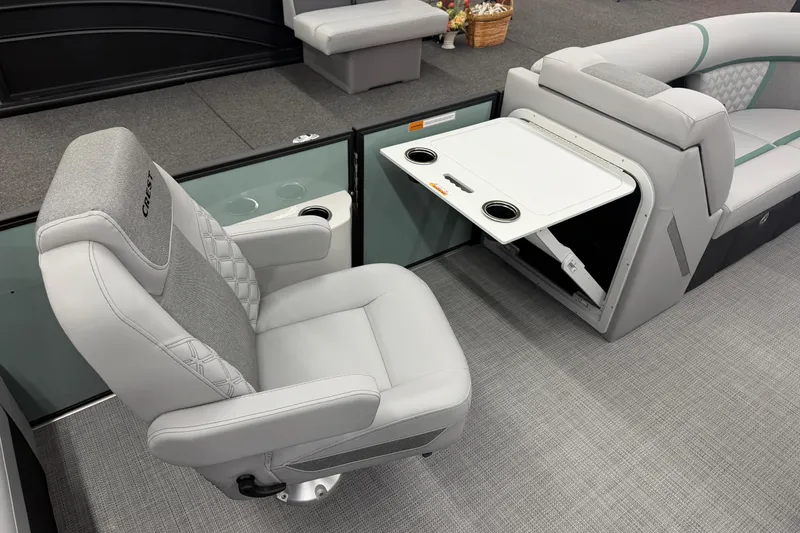 Slide: The Image of 2026 Crest Conquest 230 SLSC boat interior with luxurious seating and foldable table. - 5