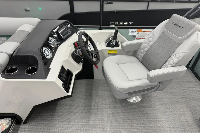 Slide: The Image of Captain's seat and helm of 2026 Crest Conquest 230 SLSC boat, featuring modern controls. - 8