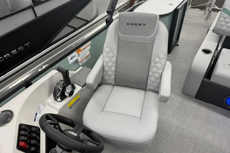 Slide: The Image of Captain's chair in 2026 Crest Conquest 230 SLSC boat, featuring sleek design and controls. - 9