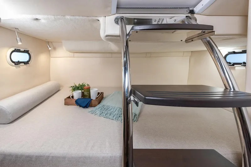 Slide: The Image of Manufacturer Provided Image: Interior cabin of 2026 Regal 26 XO boat with cozy bedding and modern design. - 14