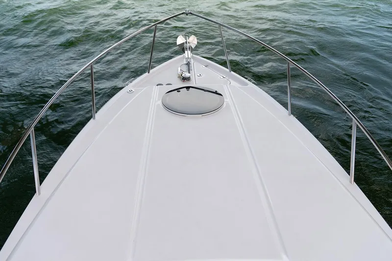 Slide: The Image of Manufacturer Provided Image: Bow of 2026 Regal 26 XO boat on water, featuring sleek design and railing. - 5