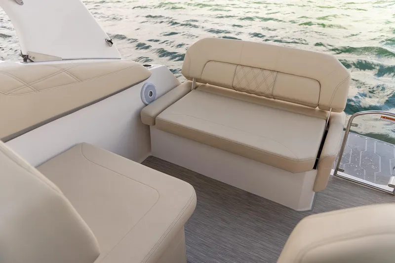 Slide: The Image of Manufacturer Provided Image: Luxurious seating on 2026 Regal 26 XO boat with beige upholstery, overlooking water. - 7