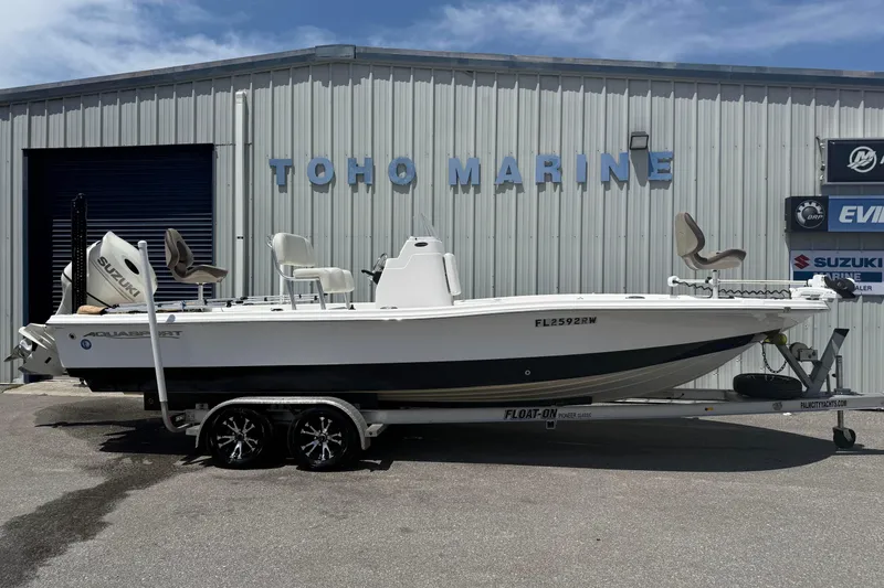 The Image of 2019 Aquasport 224 Bay boat on trailer at Toho Marine dealership. - 1