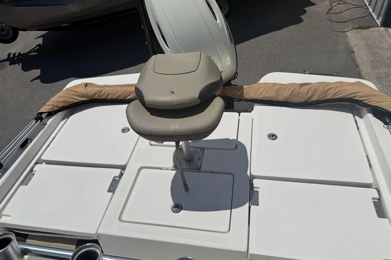 Slide: The Image of 2019 Aquasport 224 Bay boat deck with seating and storage compartments. - 10