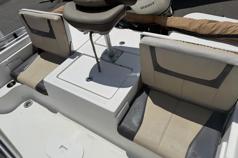 Slide: The Image of 2019 Aquasport 224 Bay boat interior with seating and storage compartments. - 11