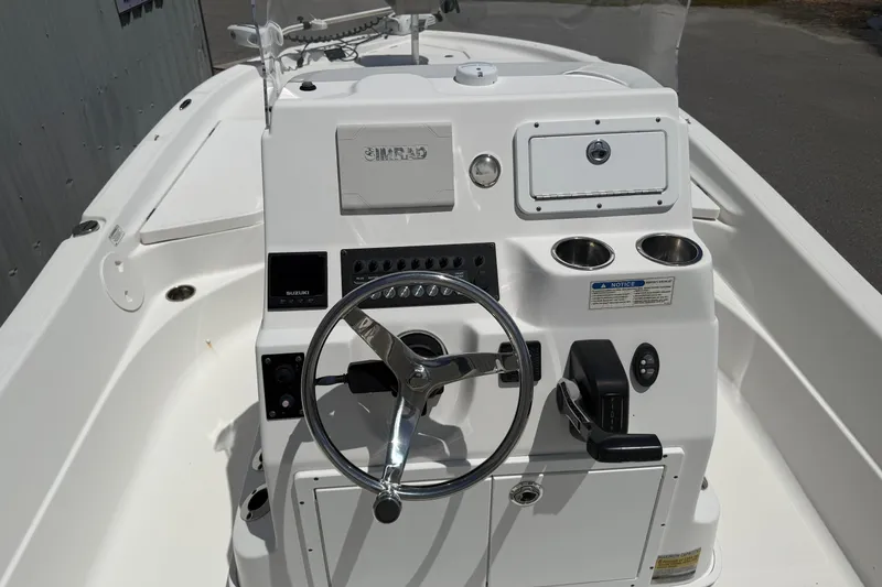 Slide: The Image of 2019 Aquasport 224 Bay boat console with steering wheel and controls. - 12