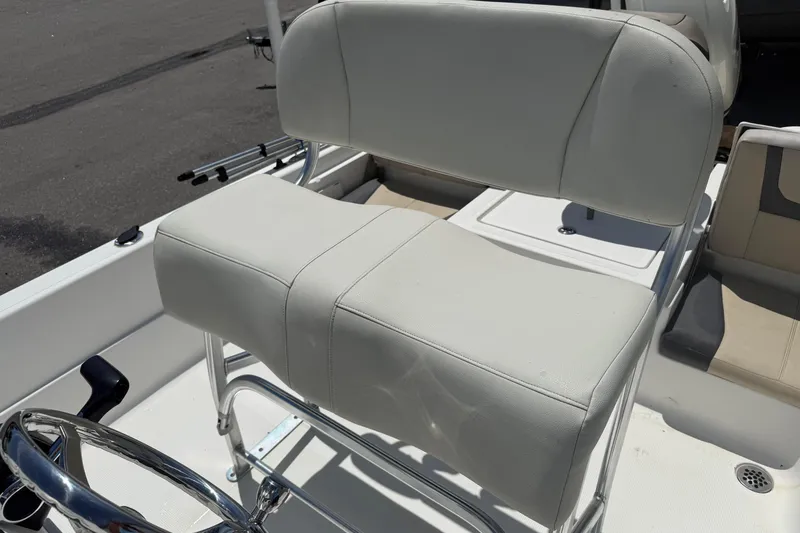 Slide: The Image of 2019 Aquasport 224 Bay boat seat with white upholstery and chrome accents. - 13