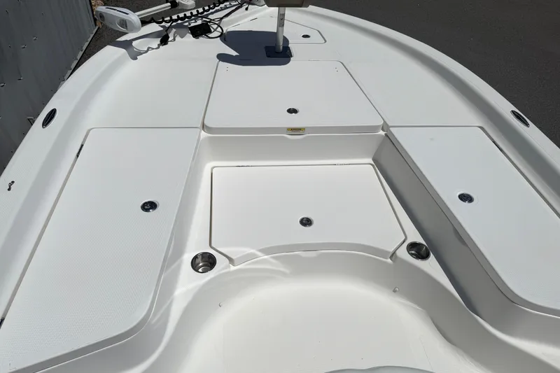 Slide: The Image of 2019 Aquasport 224 Bay boat deck with storage compartments and trolling motor. - 14