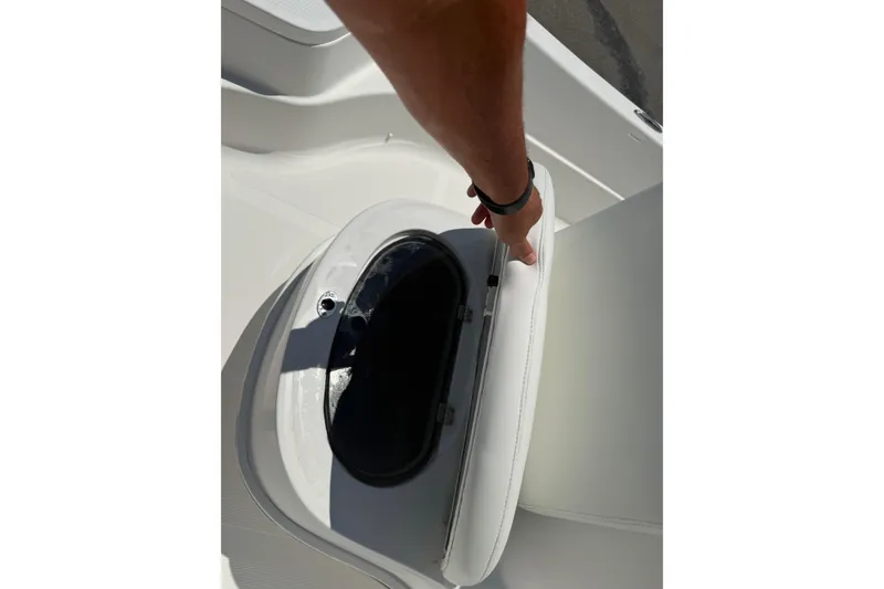 Slide: The Image of 2019 Aquasport 224 Bay boat seat storage compartment being opened. - 16