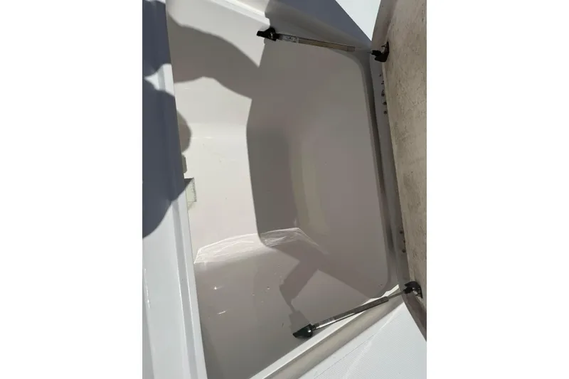 Slide: The Image of Open storage compartment on a 2019 Aquasport 224 Bay boat. - 20